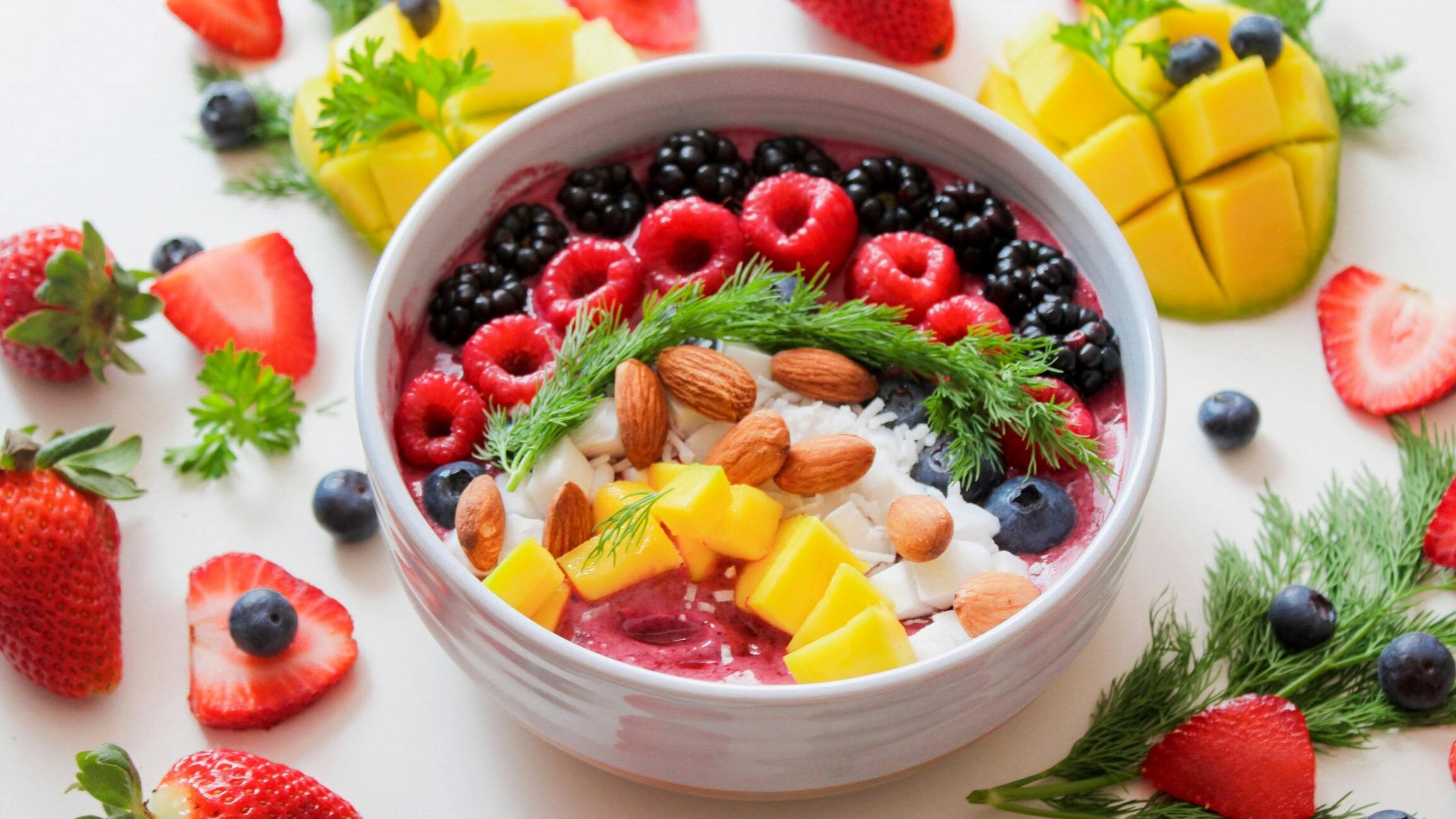 Colorful smoothie bowl with fresh fruits and almonds, perfect for a healthy breakfast.